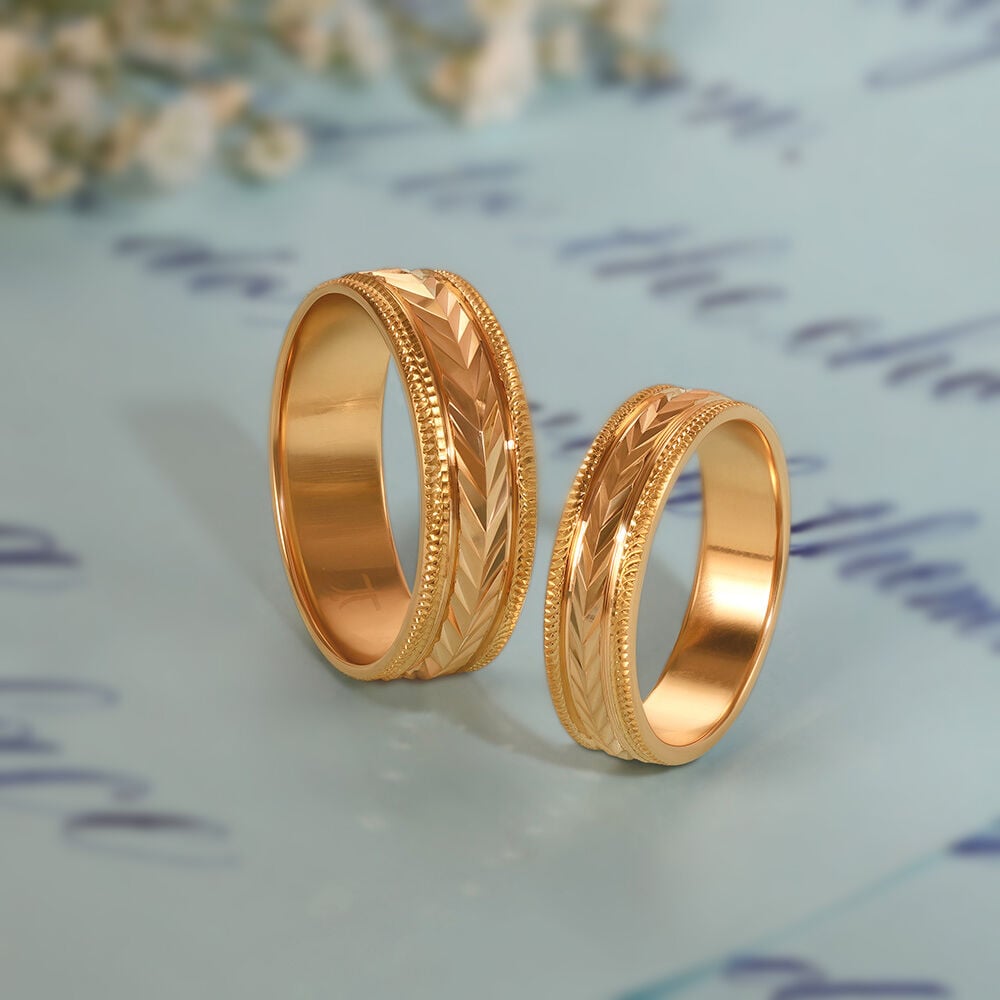 Gold love bands for couple top tanishq