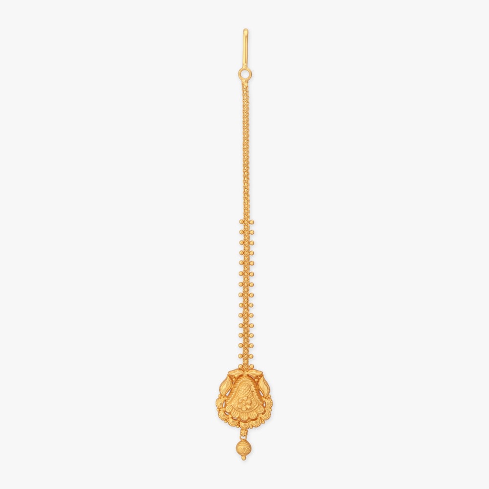 Petals unfold gracefully on this 22 Karat yellow gold Maang Tikka, detailed with a floral centre, curved leaf motifs, scalloped edging and a dangling bead.,,hi-res image number null
